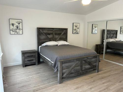 a bedroom with a large bed and a mirror at Walking Distance to Stagecoach in Indio