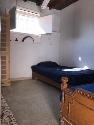 a small bedroom with a bed and a window at LUKA House in Dahab