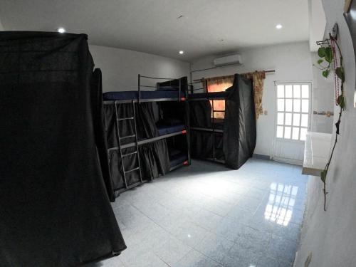 a room with a room with bunk beds in it at Casamaya Hostel & Diving in Cozumel