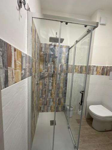 a shower stall in a bathroom with a toilet at The Stars miaj in Campagna