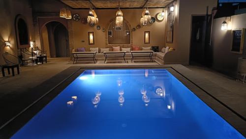 a swimming pool with ducks in the water in a living room at Riad Dar Poublanc in Merzouga