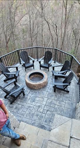 a group of chairs and a fire pit on a patio at SunnySierra Cabin in Sevierville