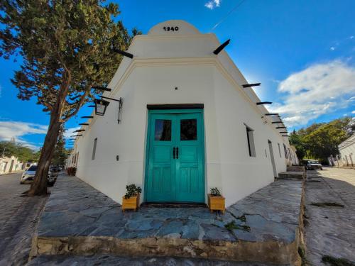 a small church with a blue door on a street at La Vieja Esquina in Cachí