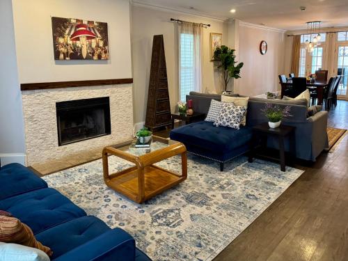 a living room with blue couches and a fireplace at 5 Bedroom Huge House in Best Location Parking Fireplace Back Yard in Chicago