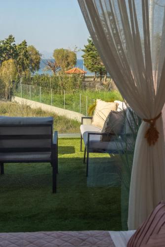 a room with two benches and a curtain at Antonakis Villa Rhodes Private Pool & Jacuzzi Retreat in Kremasti