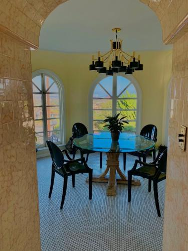 a dining room with a table and chairs and a chandelier at SpanishFairytale4bd3ba in San Pedro