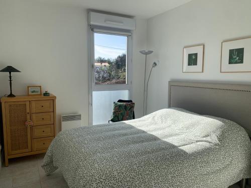 une chambre blanche avec un lit et une fenêtre dans l'établissement Grand T2 Pointe Rouge plage, à Marseille