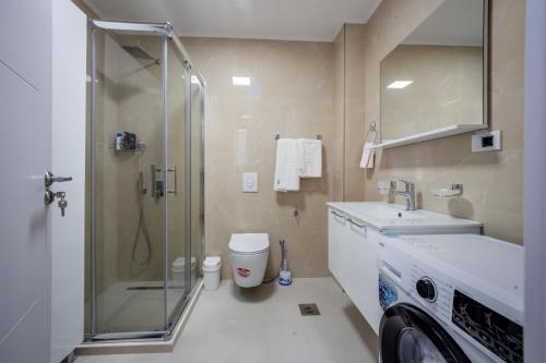 a bathroom with a shower and a sink and a toilet at Cozy Coastal Bliss 2 in Ulcinj