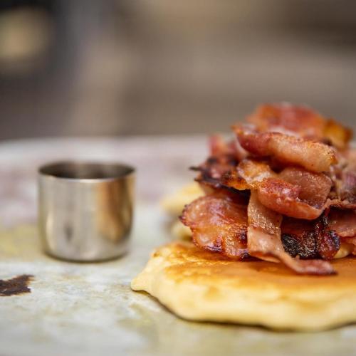 a pile of bacon on top of a pancake at Eddrachilles Hotel in Scourie