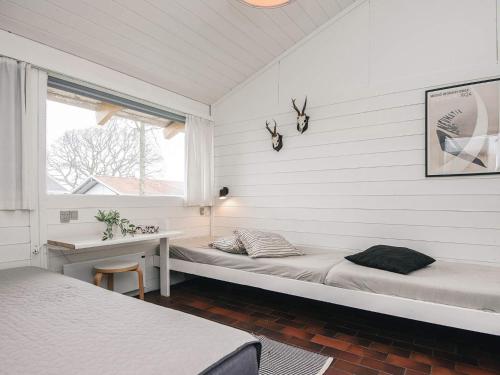 a room with two beds and a desk and a window at 5 person holiday home in Aabenraa-By Traum in Aabenraa