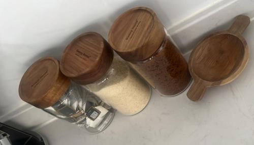 three wooden containers sitting on top of a counter at Homely and Spacious 2 bed at Marina Bay in Nairobi