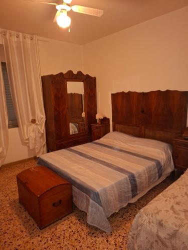 a bedroom with a bed and a dresser and a mirror at B&B Ca' del Grillo in Castel del Rio