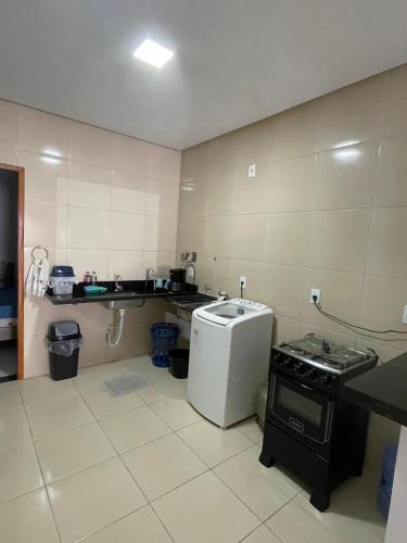 a kitchen with a sink and a stove in it at GREAT HOUSE in Manaus