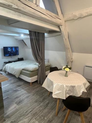 une chambre avec un lit et une table dans une pièce dans l'établissement Modern and bright studio, à Bourges