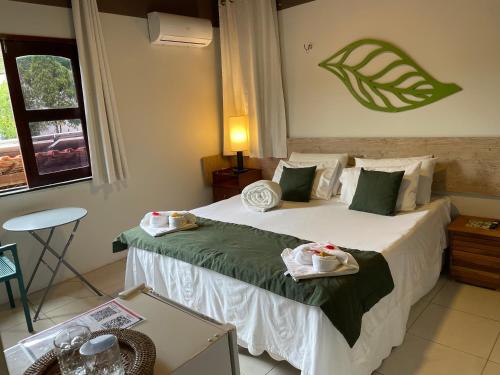 a hotel room with a bed with two babies on it at Pousada Monteflor Guaramiranga-CE in Guaramiranga