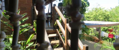 a wooden staircase in a garden with plants at LA LOMA LINDA, Bungalows, Yoga and Feldenkrais, STARLINK INTERNET in Zipolite