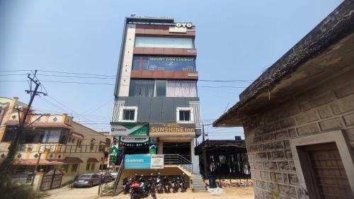 a tall building on the side of a street at Spot On Sunshine Inn in Hyderabad