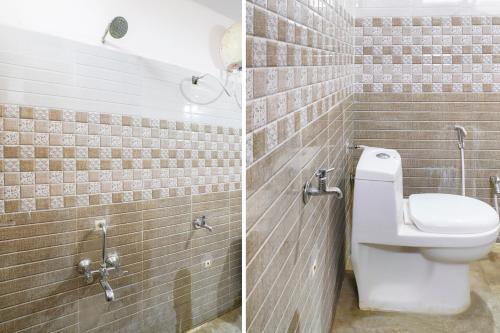 a bathroom with a toilet in a brick wall at Spot On Sunshine Inn in Hyderabad