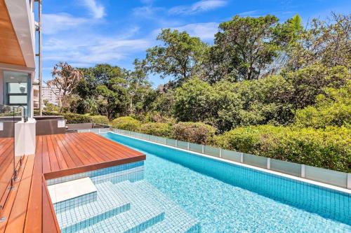 a swimming pool in the backyard of a house at BEACH01- Mooloolaba Beachfront Apartment with Private Pool in Mooloolaba