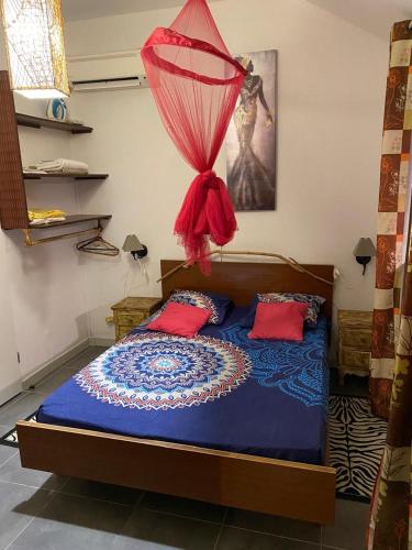 a bedroom with a bed with a net on it at Chez HENRIETTE in Terre de Bas