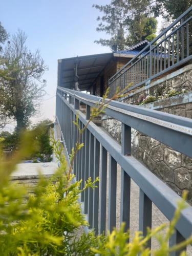 a metal railing on the side of a building at Rima adventure Tent munnar Suryanelli in Suryanelli