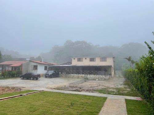 a car parked in a parking lot next to a house at Pousada Monteflor Guaramiranga-CE in Guaramiranga
