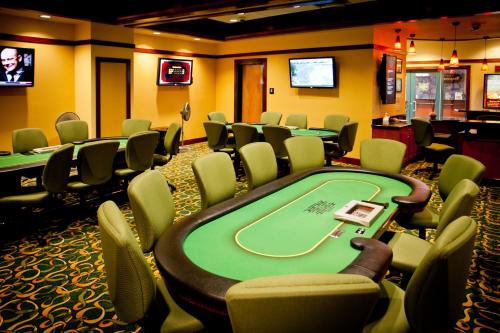 a poker room with a bunch of tables and chairs at Lucky 7 Casino & Hotel (Howonquet Lodge) in Smith River