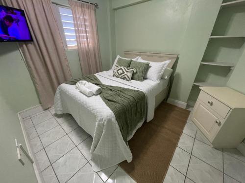 a small bedroom with a bed and a television at Modern North Side Hideaway with Aircon in Dick Hill