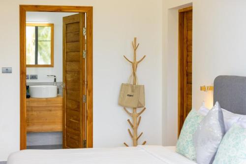 a bedroom with a bed and a bathroom with a sink at VILLA CAMILLE - SEAVIEW - 4 Bedrooms in Koh Samui 