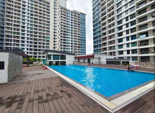 a large swimming pool in the middle of some buildings at The Garden 6Pax Comfort Convenient Stay BySTAY in Johor Bahru
