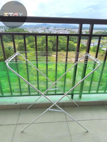 a metal chair sitting on top of a balcony at The Garden 6Pax Comfort Convenient Stay BySTAY in Johor Bahru