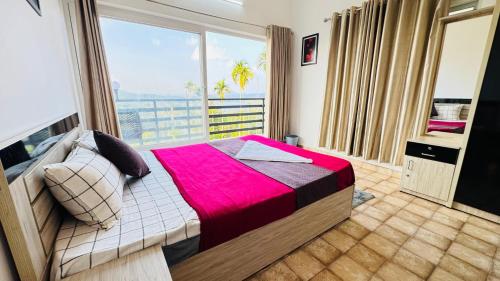 a bedroom with a bed and a large window at mountain lake view private pool villa -Wayanad in Meppādi