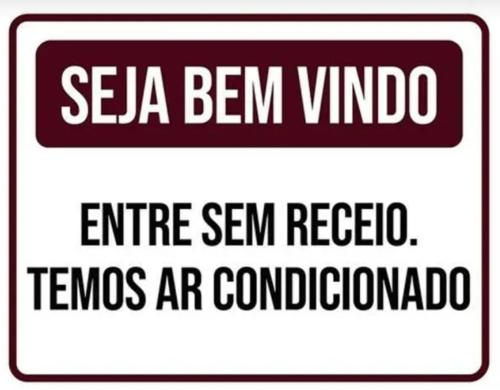 a sign with the words sea ben virus entrance san rebel tempos are at Casa da Vó Maria 08 in Goiânia