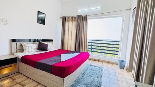 a bedroom with a bed and a large window at mountain lake view private pool villa -Wayanad in Meppādi