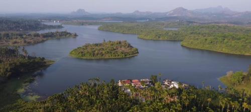 an island in the middle of a large lake at mountain lake view private pool villa -Wayanad in Meppādi