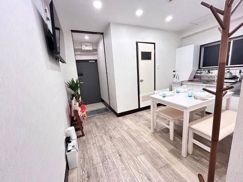 a kitchen and dining room with a white table and chairs at Y-Shinjuku City, Okubo 5F-SJ0070 in Tokyo