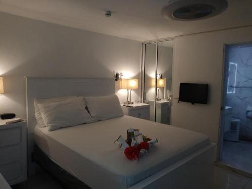 a bedroom with a bed with two stuffed animals on it at Luxury Apt for 4 Comfy Quiet AC & WiFi in San Felipe de Puerto Plata
