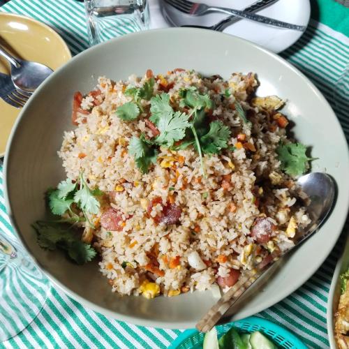 a bowl of rice with a spoon on a table at Ban Kru Ae HomeHostel in Bangkok