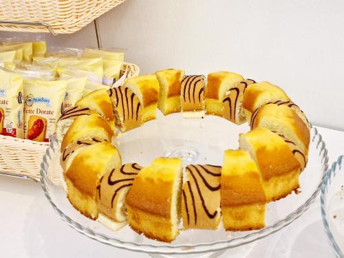 a cake on a glass plate on a table at Hotel Firenze 2000 in Florence