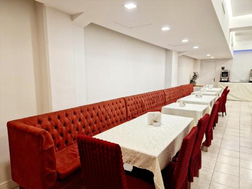 a row of tables and chairs in a restaurant at Hotel Firenze 2000 in Florence
