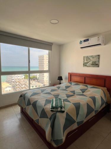 a bedroom with a bed with a view of the ocean at Suite vista al Mar Salinas in Salinas