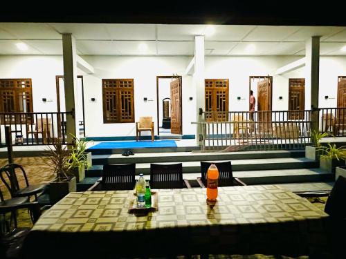 a table with drinks on top of a building at NMK Trinco Holiday Inn in Trincomalee