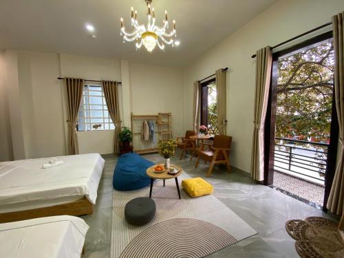 a living room with a bed and a table at Lavande Hue Homestay in Hue