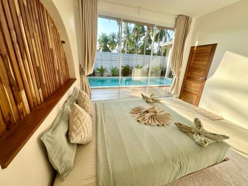 a bedroom with a bed with flowers on it at Oh'lala Two Bedroom Pool Villas in Koh Phangan