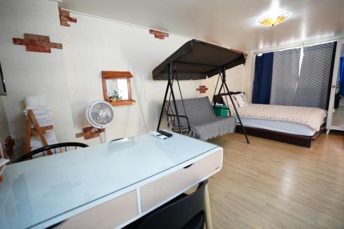 a room with a bedroom with a bed and a desk at Residence Unicorn in Seoul