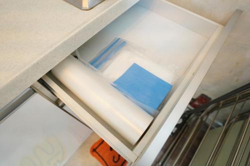 a drawer in a kitchen with a blue book on it at Residence Unicorn in Seoul