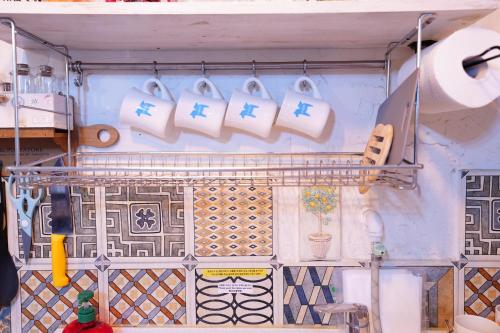 a shelf with a bunch of kitchen utensils on a wall at Residence Unicorn in Seoul