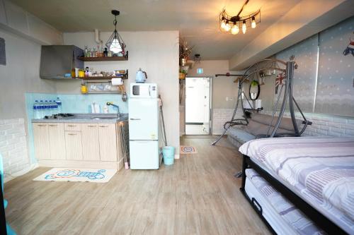 a kitchen with a refrigerator and a sink in a room at Residence Unicorn in Seoul