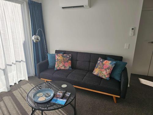 a living room with a couch and a table at Apartment in the Heart of Queenstown in Queenstown