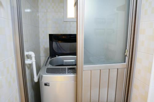 a small kitchen with a stove and a refrigerator at Residence Unicorn in Seoul